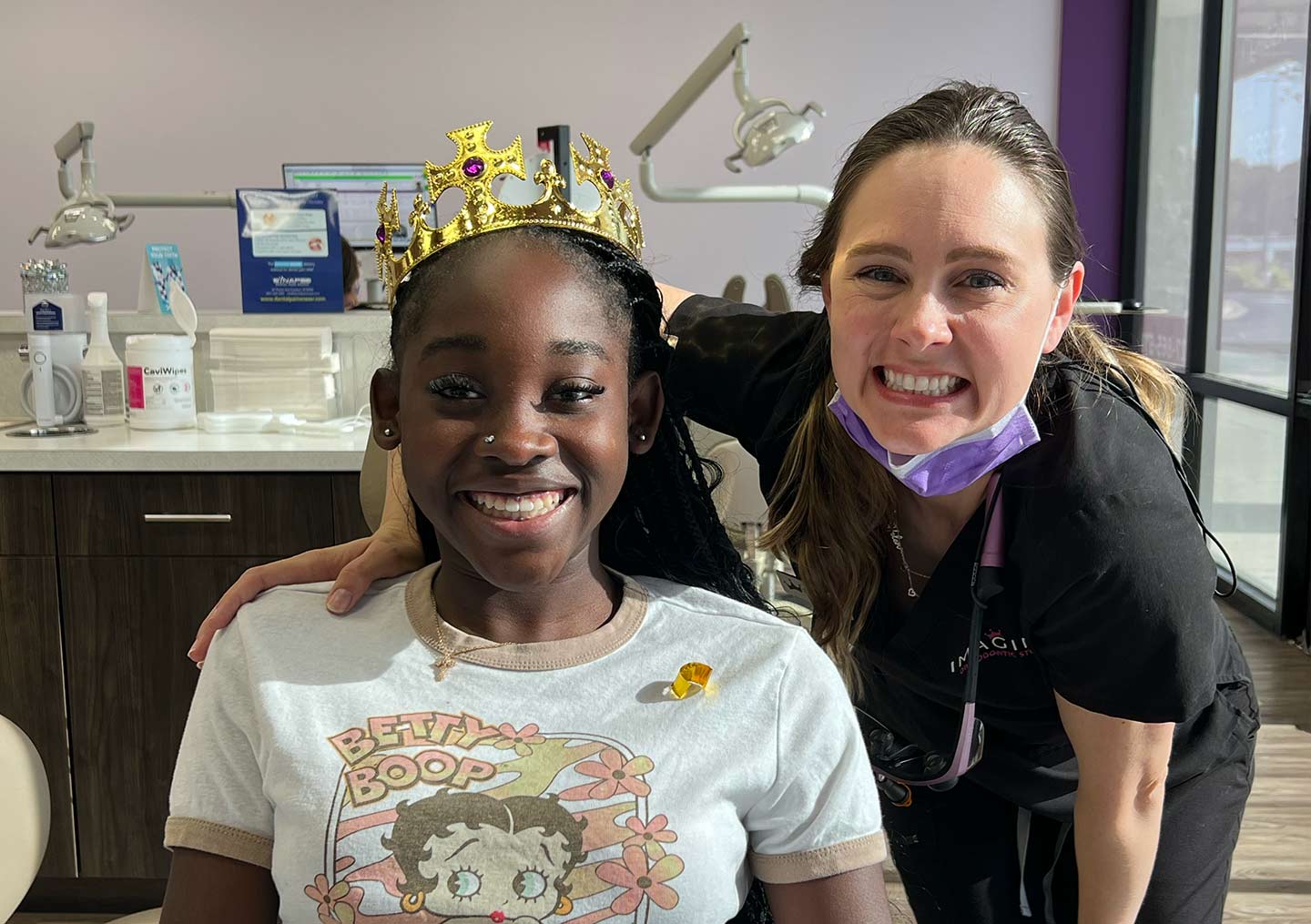 Orthodontist and patient smiling
